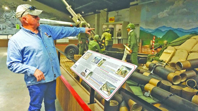 Exhibits Specialist Zane Mohler provides background on the latest addition to the new gallery of the U.S. Army Artillery Museum, a diorama of a Vietnam War fire support base.