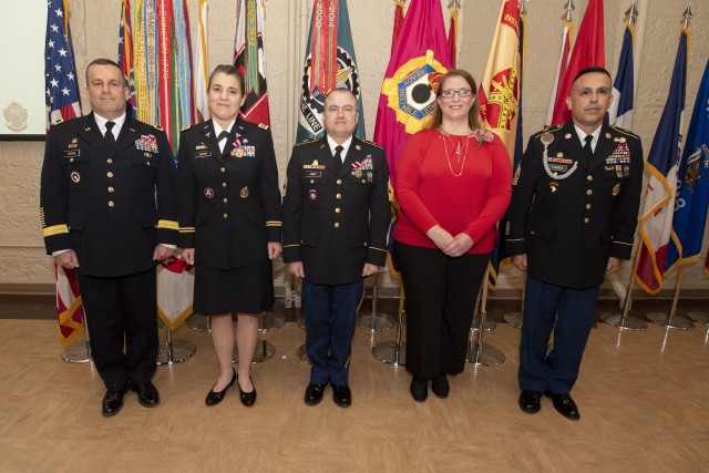 Retirees – two Soldiers and a civilian -- gather for a photograph following the retirement ceremony held March 12 in Heritage Hall, Rock Island Arsenal, Illinois. Maj. Gen. Steven Shapiro, commanding general, U.S. Army Sustainment Command, presided over the ceremony assisted by Command Sgt. Maj. Marco Torres, command sergeant major, ASC.