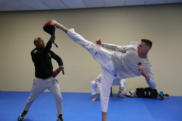 Pfc. Russell Gresham practices a hook kick with World Class Athlete Assistant Coach Terrence Jennings. 