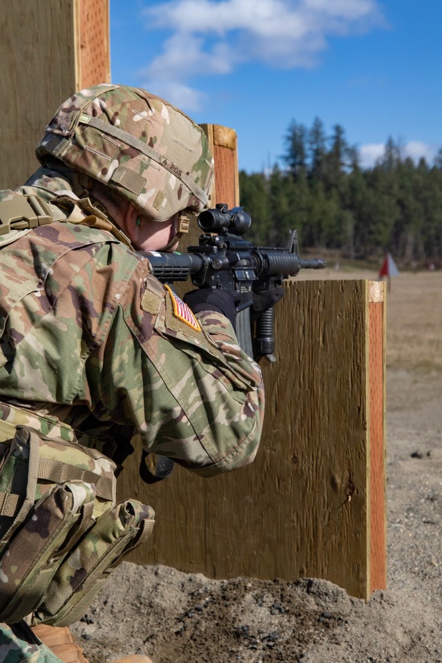 Sgt. Paul Gill, an air defense battle management system operator with Headquarters Support Company, Headquarters and Headquarters Battalion, I Corps, prepares to engage a target in the kneeling supported position at Joint Base Lewis-McChord, Washington, March 3, 2020. The new weapons qualification has replaced kneeling unsupported with kneeling supported. (U.S. Army photo by Pfc. Laurie Ellen Schubert)