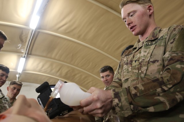 U.S. Army Spc. Michael Schnee, 4-118th Headquarters Battalion, 1-18th Cavalry Regiment, 30th Armored Brigade Combat Team, compresses a bag valve inserted into the trachea of the Tactical Combat Casualty Care Exportable model of medical training mannequin in the U.S. Central Command region on Feb. 12, 2020. The TC3X is a state of the art medical training device used to simulate an actual casualty that could be found on the battlefield. (U.S. Army photo by Pfc. Andrew Zook)