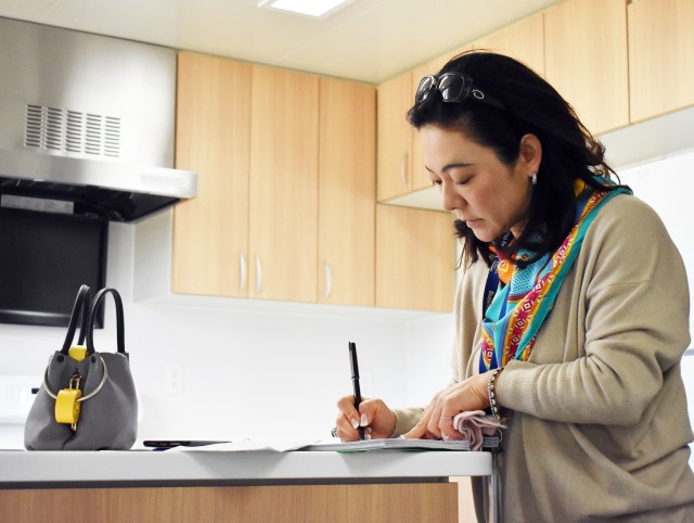 Tomoko Sako, a housing inspector for the Housing Division, Directorate of Public Works, U.S. Army Garrison Japan, checks her paperwork while doing an inspection inside a housing unit in the Sagamihara Family Housing Area, Japan, March 13, 2020.