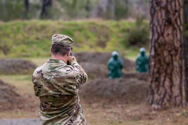 Lt. Col. Christopher Osgood, military intelligence staff officer with Headquarters Support Company, Headquarters and Headquarters Battalion, I Corps, begins the new M9 pistol qualification while in the standing position at Joint Base Lewis-McChord, Washington, March 3, 2020. The M9 pistol qualification involves a standing portion, then kneeling and finishes with a walking engagement toward the targets. (U.S. Army photo by Pfc. Laurie Ellen Schubert)