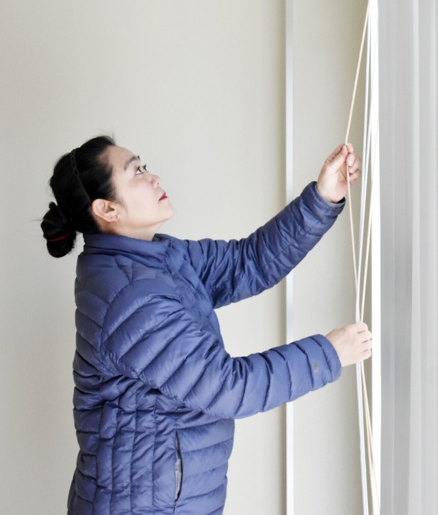 Mamiko Takishima, a housing inspector for the Housing Division, Directorate of Public Works, U.S. Army Garrison Japan, checks blinds inside a housing unit in the Sagamihara Family Housing Area, Japan, March 12, 2020.