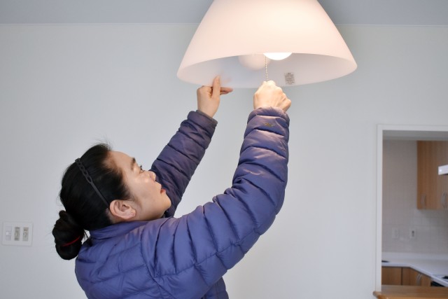 Mamiko Takishima, a housing inspector for the Housing Division, Directorate of Public Works, U.S. Army Garrison Japan, checks lighting inside a housing unit in the Sagamihara Family Housing Area, Japan, March 12, 2020.