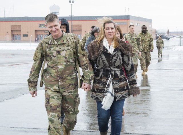 Command Sgt. Maj. Samuel Roark, 10th Mountain Division (LI) senior enlisted adviser, and his wife walk together before he boards a plane for deployment. After 30 years of service, Roark is ready to embrace the changes to come with his retirement...