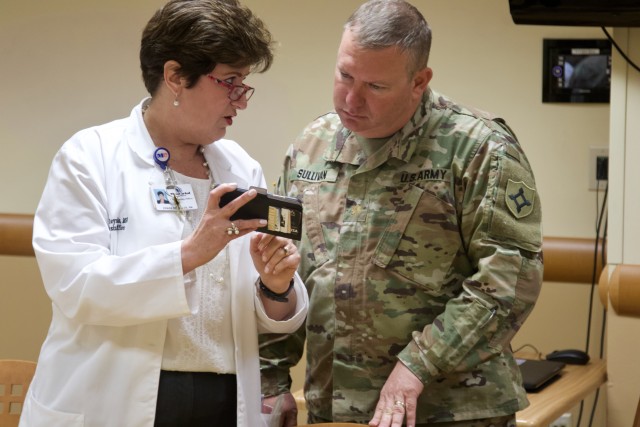 Denise Reynolds (left), the chief nursing officer at Memorial Hospital West, discuss tactics for the coronavirus drive-thru testing facility with Maj. Mark Sullivan (right), with the Florida National Guard’s medical detachment, March 16, 2020....
