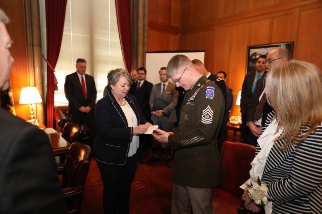 Command Sgt. Maj. Samuel Roark, 10th Mountain Division (LI) senior enlisted adviser, meets with State Senator Pattie Ritchie in Albany during a Fort Drum Day event at the Capitol. After 30 years of service, Roark is preparing to embrace the...