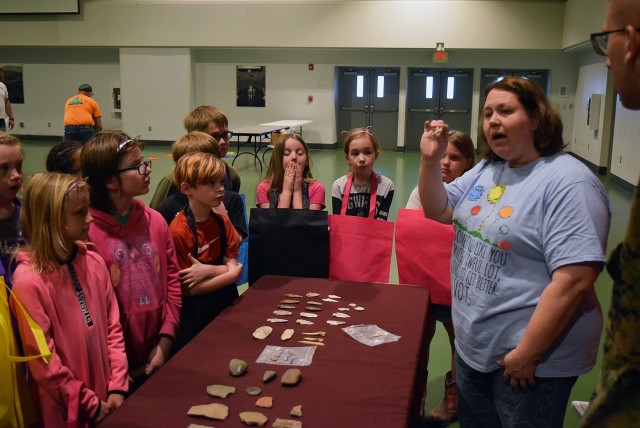 Stephanie Nutt, Directorate of Public Works cultural resource coordinator, shows archaeological artifacts to students at the 2019 Earth Day Fair. In February, DPW’s environmental and cultural resource management programs won two Secretary of the Army Environmental awards.
