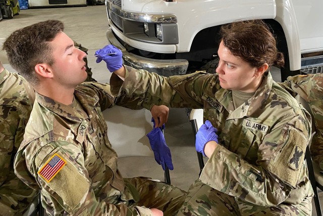 Medics with the Louisiana Army and Air National Guard conduct training with the Department of Health and Human Services to ensure proper protection and administering of drive thru testing, March 18, 2020 in New Orleans. (U.S. Army National Guard...