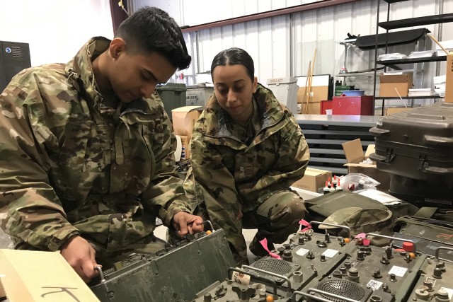 U.S. Army Pfc. Noel Zarazua and Pvt. Citlalit Flores of the California Army National Guard's 115th Regional Support Group check radio equipment at the Roseville Armory March 18, 2020, in Roseville, California. California National Guard units...