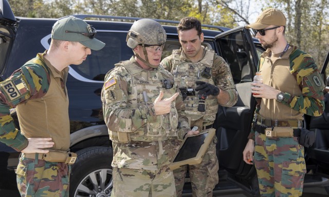 Staff Sgt. David Ervin (left) discusses an X-ray of an unmanned aircraft system with internal and external explosives with the Belgian EOD Group as Staff Sgt. Jonathan Pando examines photos of the device during Raven’s Challenge on March 4,...