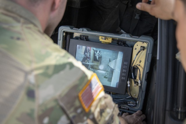Sgt. Tyler Grieve, 744th Ordnance Company (EOD), investigates where someone has been making home-made explosives via robot training scenario during Raven’s Challenge on March 4, 2020. Raven’s Challenge is an annual series of events that...