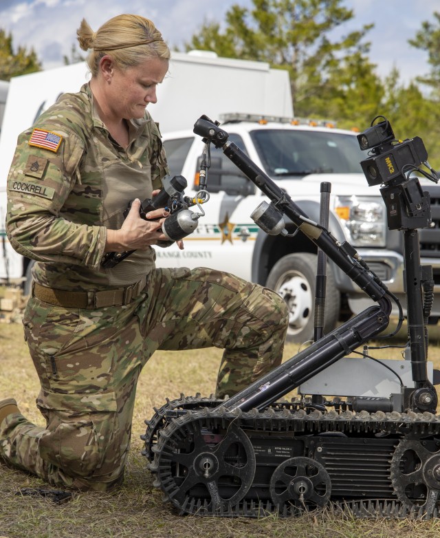 Staff Sgt. Heather Cockrell, 744th Ordnance Company (EOD), adjusts the arm of a robot the during Raven’s Challenge on March 4, 2020. Raven’s Challenge is an annual series of events that enhances the interoperability of explosive ordnance...