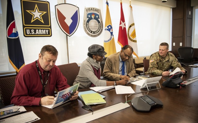Donna Franklin, center left, briefs Robert Moore, the Deputy to the Commanding General for U.S. Army Security Assistance Command, on foreign military sales audit readiness. Franklin is USASAC's chief of Internal Review and Controls office. Franklin, along with John Sanders from USASAC Resource Management, left, and COL Curt Stewart, far right, USASAC's Chief of Staff, are briefing Moore on steps the command is undertaking to prepare for a mandated audit of FMS business processes which fall under the Army Security Assistance Enterprise, at Redstone Arsenal, AL. The full-scope audit is scheduled for fiscal year 2022 and will involve all organizations involved in Army FMS.