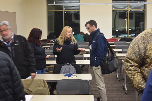Real estate specialists Stephanie Dupey (left) and Penny Caldwell (right),
talk to a member of the public at the Pool 2 dredged material management
plan public meeting in Cottage Grove, Minnesota, on Dec. 9.