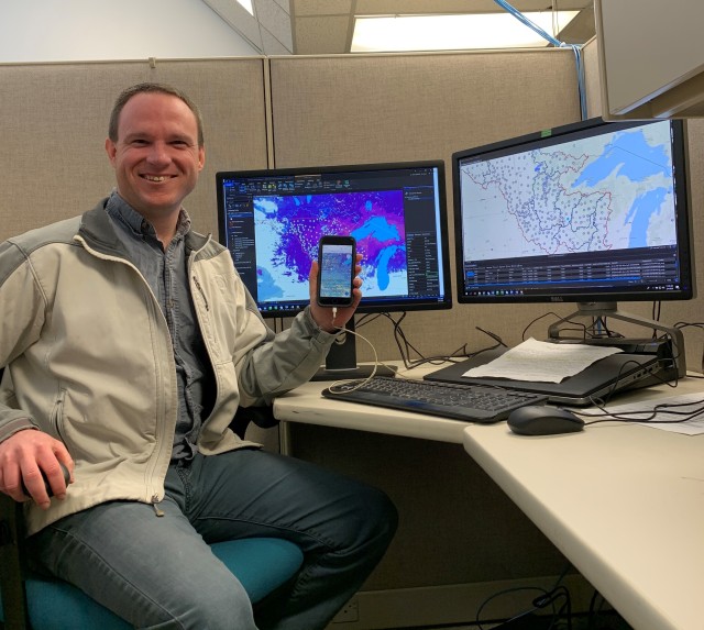 Jesse Scott, hydrologic technician, shows Collector for GIS on his phone, a mobile
application that will allow the district water management team and river regulators to see data from snow surveys real-time.