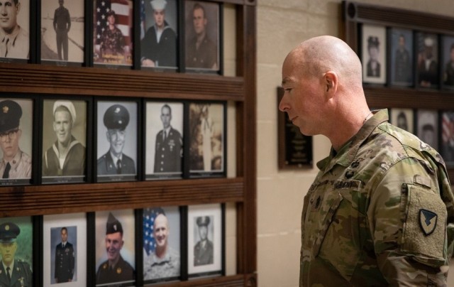 Garrison Command Sgt. Maj. Billy Counts takes a moment to reflect as he walks through Buckhorn High School’s Hall of Heroes in 2019.