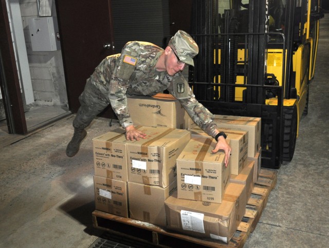 A Soldier from the 563rd Medical Logistics Company unloads a delivery of medical supplies to support the medical materiel response to COVID-19. (U.S. Army photo by Sgt. 1st Class Gerald Sim)
