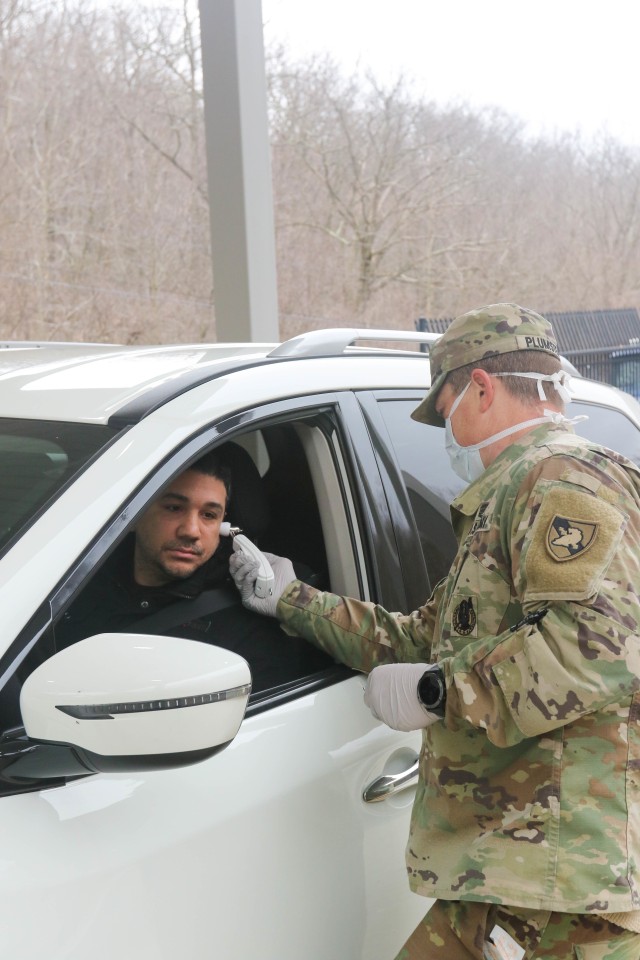 Capt. John Plumstead, the executive officer for the center for enhanced performance, conducts a quick health screening and temperature check at Stony Lonesome Gate Wednesday. All people entering West Point are now screened for possible symptoms of the COVID-19. Anyone with symptoms will be given further screening and may be directed to medical facilities or self-quarantine.