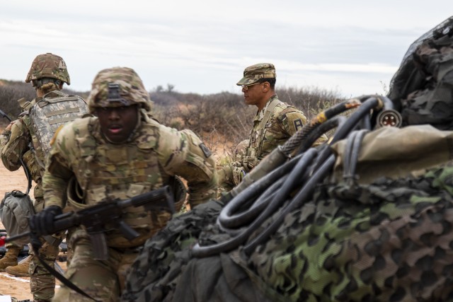 Sgt. 1st Class Darren Thomas (right), medical observer, coach/ trainer assigned to 2nd Battalion, 362 Field Artillery Regiment, 5th Armored Brigade, First Army Division West observes during a mass casualty exercise near Fort Bliss, Texas, March...