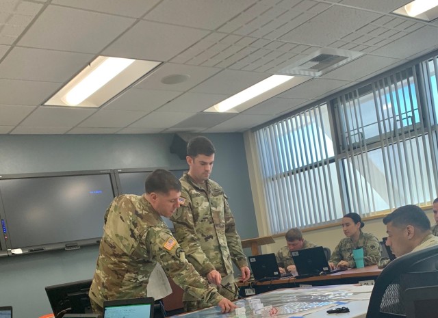 BSNCOC redesign and validation underway
Sgt. 1st Class Ryan Krisrow (left) and Sgt. Keenan Hoeft (right), perform a Combined Arms Rehearsal briefing to fellow participants of the BSNCOC 10-20, students of the course graduated March 21.