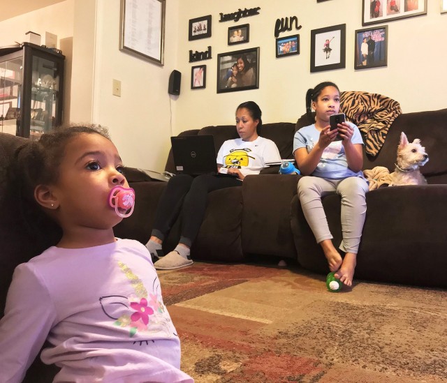 U.S. Military Academy Public Affairs NCOIC Sgt. 1st Class Josephine Pride listens to briefings on Microsoft Teams from her laptop to stay abreast of the West Point situation while balancing taking care of her family during its 14-day quarantine.