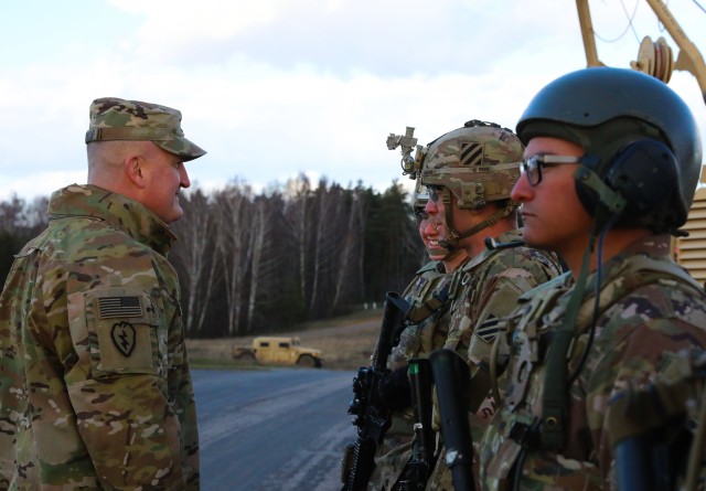 Col. Timothy O'Connor (left), 1st Infantry Division Forward Commander, speaks to Soldiers from Alpha Company, 9th Brigade Engineer Battalion, 2nd Brigade Combat Team, during a base tour at Ziemsko Airfield, Poland, on March 11, 2020. U.S. and...
