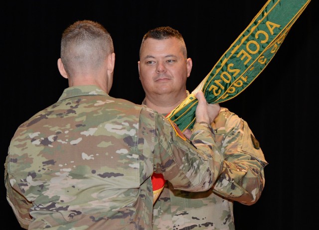 Fort Knox Garrison Commander Col. CJ King passes the Garrison colors to incoming Garrison Command Sgt. Major William Fogle during the Change of Responsibility Ceremony held at Fort Knox&#39;s Waybur Theater March 27.