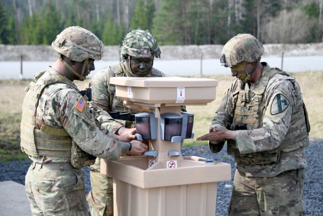 U.S. Soldiers assigned to 2nd Armored Brigade Combat Team, 1st Cavalry Division use a hand-washing station to reduce the potential spread of COVID-19 during training at the 7th Army Training Command’s Grafenwoehr Training Area, Germany, March 19, 2020. (U.S. Army photo by Gertrud Zach)