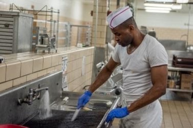 A Soldier with the 3d U.S. Infantry Regiment (The Old Guard) cleans at the dining facility, DFAC, on Joint Base Myer - Henderson Hall as part of the shift to a grab-and-go serve system, March 19, 2020. The shift is part of the DFAC’s implemented changes to combat COVID-19.