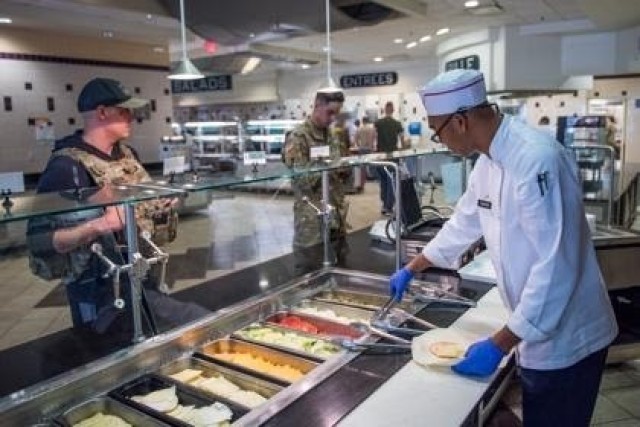 A Soldier with the 3d U.S. Infantry Regiment (The Old Guard) prepares a sandwich at the dining facility, DFAC, on Joint Base Myer - Henderson Hall as part of the shift to a grab-and-go serve system, March 19, 2020. The shift is part of the...