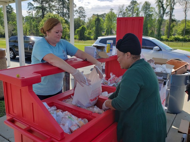 Teya Ware (left) and Shaneka Smalls, both with Kessler Elementary School’s cafeteria staff, work to serve Fort Stewart Families free breakfast and lunch meals for the community’s children March 25, 2020 as a result of the recent coronavirus-triggered school closings at Fort Stewart, Georgia. The Fort Stewart Meal Program is providing free grab-and-go lunch and breakfast meals to children in the ages zero through 18 years old for as long as the coronavirus-induced school closures continue. The meals are being handed out at four locations at Fort Stewart between the hours of 11 a.m. and 1 p.m., Monday through Friday, to include regularly-scheduled off times of spring break and teacher training days. The locations are Murray Elementary School, Diamond Elementary School, Kessler Elementary School, and Building 5601 on Davis Avenue. (U.S. Army photo by Sgt. 1st Class Jeff Smith)