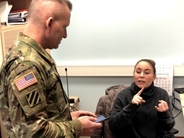 Ashley Bryles, USAG Rheinland-Pfalz emergency operations manager, answers questions for Command Sgt. Maj. Brett Waterhouse, USAG RP command sergeant major, in the garrison emergency operations center.