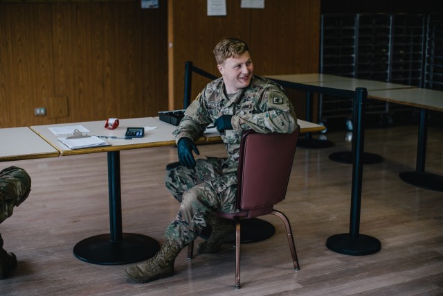 Paratroopers assigned to 1st Battalion, 503rd Infantry Regiment, 173rd Airborne Brigade wait to sign people in during the re-opening of the Italian Mensa on Caserma Ederle, which will offer additional food options for personnel currently complying...