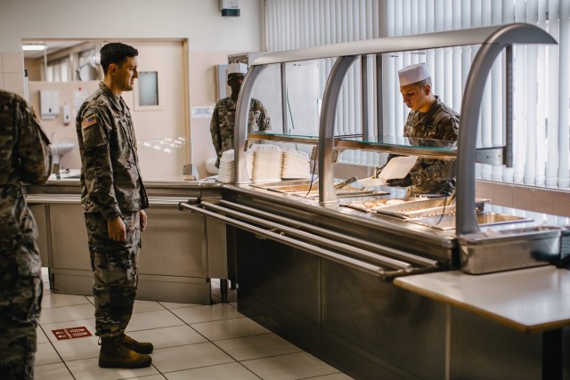Culinary specialists assigned to 1st Battalion, 503rd Infantry Regiment, 173rd Airborne Brigade prepare food during the re-opening of the Italian Mensa on Caserma Ederle, which will offer additional food options for personnel currently complying...