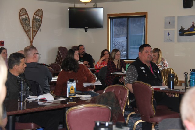 Members of the Wisconsin Inter-Service Family Assistance Committee (ISFAC) speak at the March 5 meeting held at Fort McCoy's Whitetail Ridge Ski Area Chalet. The Wisconsin ISFAC is a military/community cooperative partnership that allows service...