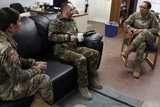 Slovenian Armed Forces Sgt. 1st. Class Damir Zalokar, a member of Kosovo Force Regional-Command East’s effects battalion visits with RC-E task force public affairs detachment commander Capt. Nadine DeMoura and non-commissioned officer in charge...
