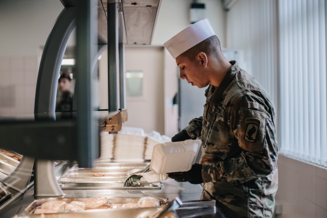 Culinary specialists assigned to 1st Battalion, 503rd Infantry Regiment, 173rd Airborne Brigade prepare food during the re-opening of the Italian Mensa on Caserma Ederle, which will offer additional food options for personnel currently complying...