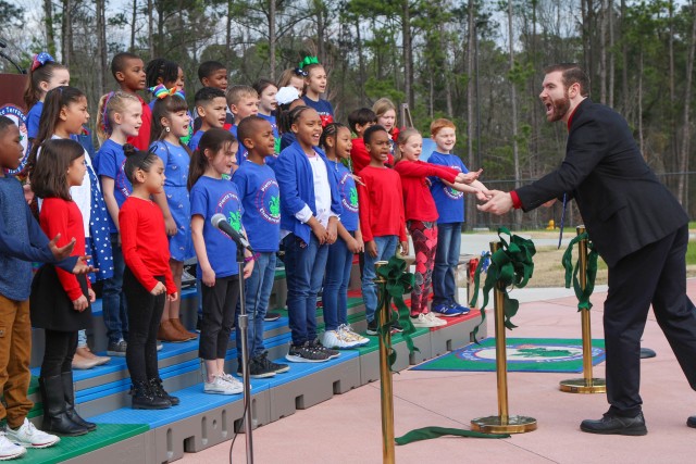 Alan Dahany leads Pierce Terrace Elementary Students in singing “Welcome to Our School” during a ribbon cutting ceremony Feb. 12. While students started attending classes at the new school after the Christmas holiday break, the ribbon cutting...
