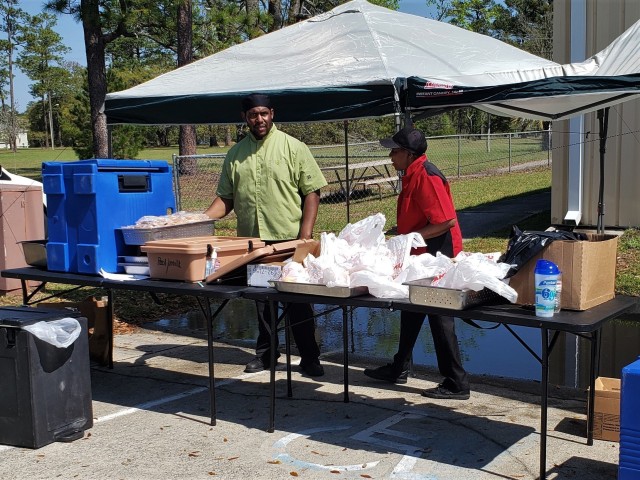 Workers at Fort Stewart help Families receive free breakfast and lunch meals for the community’s children March 25, 2020 as a result of the recent coronavirus-triggered school closings at Fort Stewart, Georgia. The Fort Stewart Meal Program is providing free grab-and-go lunch and breakfast meals to children in the ages zero through 18 years old for as long as the coronavirus-induced school closures continue. The meals are being handed out at four locations at Fort Stewart between the hours of 11 a.m. and 1 p.m., Monday through Friday, to include regularly-scheduled off times of spring break and teacher training days. The locations are Murray Elementary School, Diamond Elementary School, Kessler Elementary School, and Building 5601 on Davis Avenue. (U.S. Army photo by Sgt. 1st Class Jeff Smith)