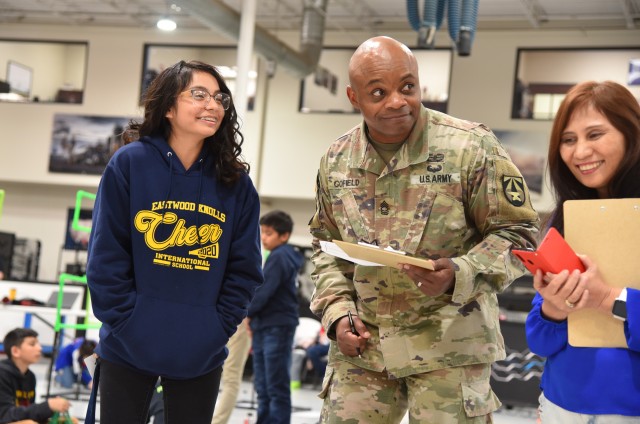 Master Sgt. Rochelle S. Cofield, Field Experiments Division NCOIC at the U.S. Army Joint Modernization Command, helps judge a robotics competition during the Five Star Innovation STEM Cup and Robotics Competition on March 7 at Western Technical College in El Paso, Texas.