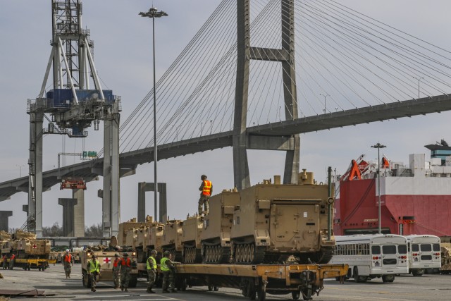 Soldiers assist in the movement and staging of various armored track vehicles in Savannah, Ga., on Feb. 5. This movement of equipment is in preparation for the DEFENDER-Europe 20 exercise which takes place in multiple European countries. DEFENDER-Europe 20 will train the joint, interagency and multinational force and help U.S. and NATO allies and partners better understand roles, responsibilities and requirements for global force deployment. (U.S. Army photo by Pfc. Daniel Alkana, 22nd Mobile Public Affairs Detachment)