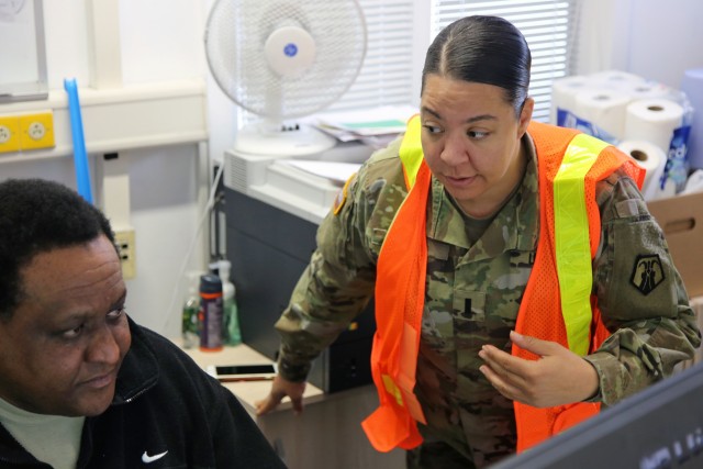 U.S. Army Reserve 1st Lt. Ava Carter, a clinical social worker with Medical Support Unit-Europe, 7th Mission Support Command, discusses warehouse functions with Wilbert Stephens, Chief of Transportation at U.S. Army Medical Materiel Center, Europe in Pirmasens, Germany, March 26, 2020. 7th MSC Soldiers are supporting the shipping and receiving functions in the warehouse to help with the high demand of Army Class VIII medical supplies during the COVID-19 pandemic.