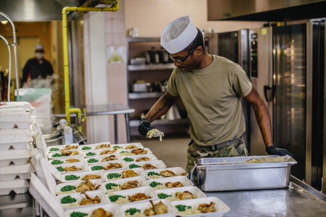 Culinary specialists assigned to 1st Battalion, 503rd Infantry Regiment, 173rd Airborne Brigade prepare meals to go during the re-opening of the Italian Mensa on Caserma Ederle, which will offer additional food options for personnel currently...