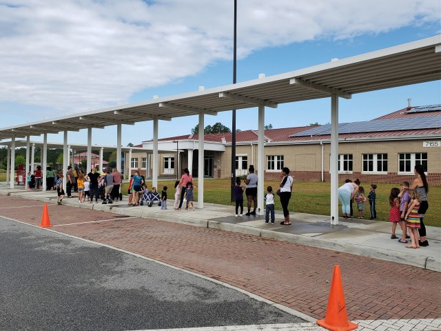 Fort Stewart Families gather at Murray Elementary School to receive free breakfast and lunch meals for the community’s children March 25, 2020 as a result of the recent coronavirus-triggered school closings at Fort Stewart, Georgia. The Fort Stewart Meal Program is providing free grab-and-go lunch and breakfast meals to children in the ages zero through 18 years old for as long as the coronavirus-induced school closures continue. The meals are being handed out at four locations at Fort Stewart between the hours of 11 a.m. and 1 p.m., Monday through Friday, to include regularly-scheduled off times of spring break and teacher training days. The locations are Murray Elementary School, Diamond Elementary School, Kessler Elementary School, and Building 5601 on Davis Avenue. (U.S. Army photo by Sgt. 1st Class Jeff Smith)
