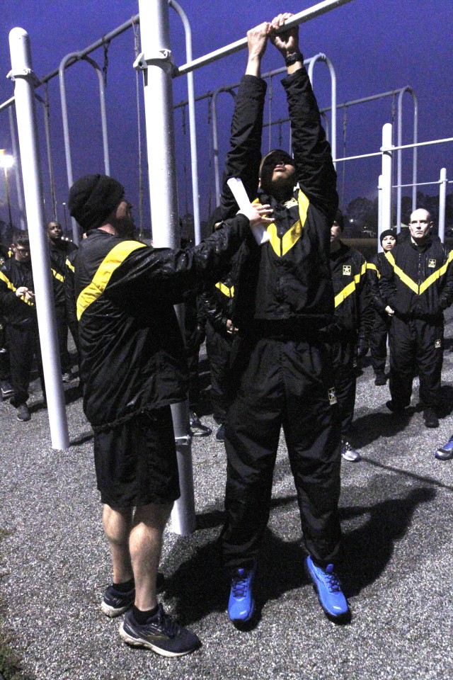1st Sgt. Kenneth Godwin and Sgt. Travis Smith, both of Headquarters Support Company, Headquarters and Headquarters Battalion, 3rd Infantry Division, lead an Army Combat Fitness Test demonstration of the leg tuck event, Jan. 31, 2020 at Fort...
