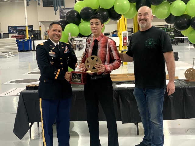 Col. Bert Shell, Joint All-Domain Command and Control Division chief at the U.S. Army Joint Modernization Command; and Shane Haggerty, president of Five Star Innovation, present Cristopher Nunez of Montwood High School with the high school division trophy on March 7 at Western Technical College in El Paso, Texas.