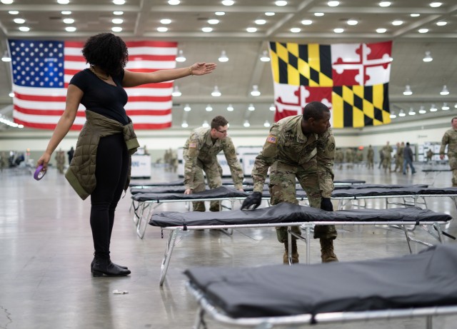 Maryland National Guard Soldiers work with local, state, and federal partners to establish a Federal Medical Station as an alternate medical facility at the Baltimore Convention Center in Maryland, March 28, 2020. The site will start with 250 beds...