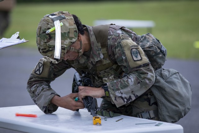 U.S. Army Sgt. 1st Class Adriana Fox, a senior religious affairs noncommissioned officer assigned as an observer/coach/trainer for the Brigade Command and Control Task Force, Operations Group, Joint Readiness Training Center, Fort Polk, disassembles her weapon during the final task of expert soldier badge testing, held at Fort Polk, Louisiana, March 27, 2020. Fox is the first religious affairs specialist to earn the badge. (U.S. Army photo by Staff Sgt. Ashley M. Morris)